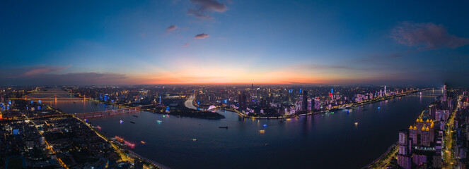 Wuhan city lights reflect on Yangtze River China at dusk