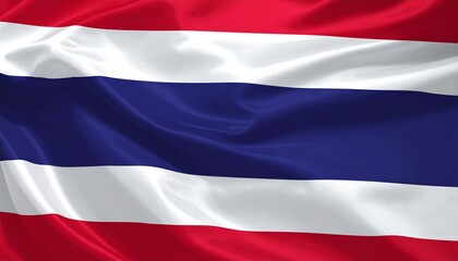Thai national flag waving in the wind with red, white, and blue horizontal stripes under a bright blue sky.