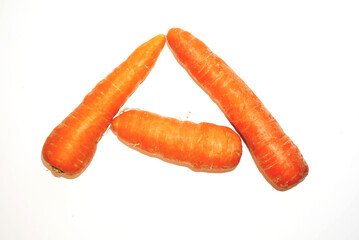 Three Fresh Carrots Arranged in a Unique Triangle Formation on a White Background A Vibrant and...