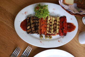 Grilled Vegetables Presented with Fresh Greens and Subtle Garnishes on a White Plate