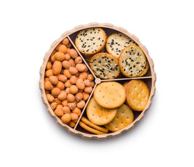 Various salty snacks in a round bowl isolated on white background.