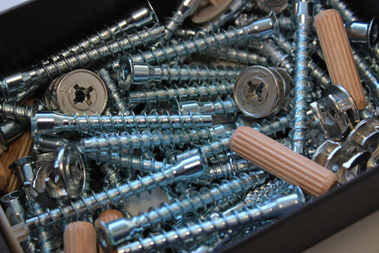 Macro Shot of Confirmat Screws, Minifix Ties, Wooden Connectors and Plastic Plugs for Wood Furniture Assembling
