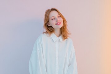 minimal bright portrait of a young woman smiling in oversized white shirt, soft pastel background, airy clean look.
