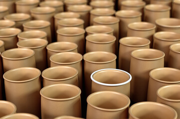 Large group of cylindrical cardboard boxes stacked together.