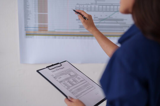 Adult architect hand pointing blueprint reviewing construction data planning building strategy project analysis office