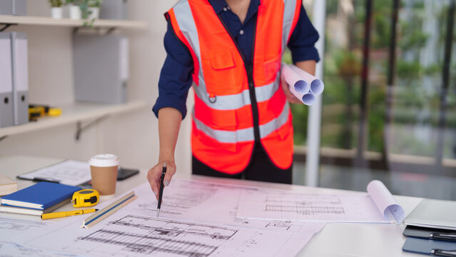 Architect engineer construction professional plans building blueprints designing urban development projects office work site safety and future structures