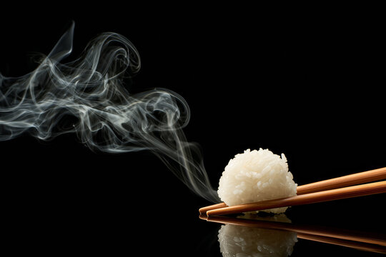 Steaming ball of rice with chopsticks