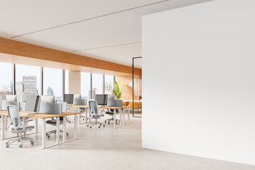 Modern open-plan office interior with large blank wall for poster mockup and panoramic city view windows, featuring minimalist design elements. 3D Rendering