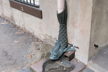 Decorative downspout, shaped like a fish, a unique metal drainpipe adds a charming and historic character to the building's facade,  Savannah, Georgia, USA