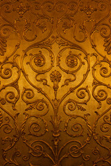 golden ornamental pattern with intricate floral and swirl details in a classic decorative style texture background