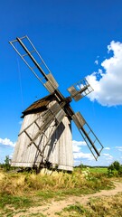 Fototapeta premium Old wooden windmill on a sunny day