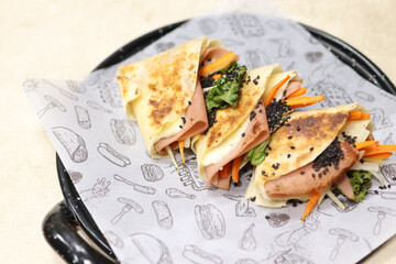 Mexican quesadillas or wraps with ham and spinach on tray