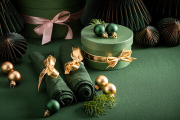 Bottle green table set for Christmas with gifts and bubbles.
