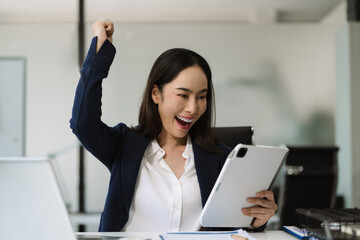 Overjoyed Asian woman celebrates a financial bonus. joyful smile, money success, and happiness...