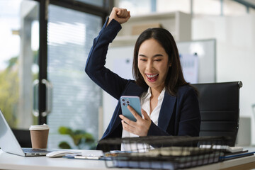 Overjoyed Asian woman celebrates a financial bonus. joyful smile, money success, and happiness...