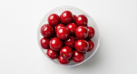 A bowl full of vibrant glossy red cherries neatly arranged showcasing their round shape and rich color