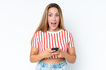 Young caucasian woman isolated on white background surprised and sending a message