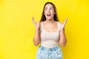 Young caucasian woman isolated on yellow background with surprise facial expression