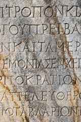 Ancient inscriptions on stone in archeological ruin in Ephesus, Turkey