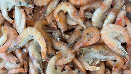Fresh shrimp piled closely together, showing texture and color for culinary background