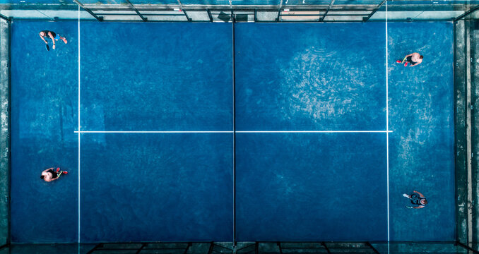 Aerial view of practice people at the blue paddle tennis courts