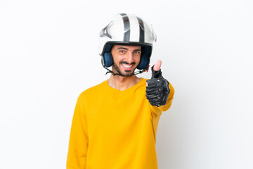 Naklejka premium Young caucasian man with a motorcycle helmet isolated on white background with thumbs up because something good has happened