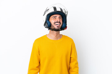 Young caucasian man with a motorcycle helmet isolated on white background laughing