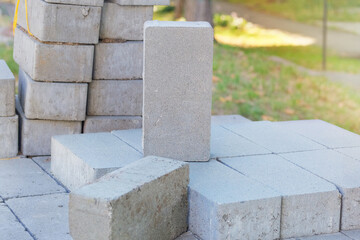 Stacked sidewalk paving stones. Textured and ready for construction. Construction material. Building construction. Gray blocks