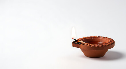 Clay Diya Lamp With Gentle Flame Illuminates Quiet Night Creating Warm Spiritual Ambiance