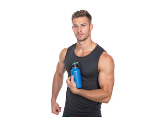 Fit man showing off strength while holding a water bottle in a bright indoor setting