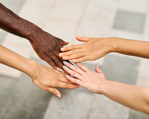A group of people are holding hands and giving each other fist bumps. Concept of unity and support among the group