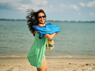 Portrait of young happy beautiful asian woman walking and running and having fun on the beach...
