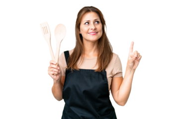 Middle age caucasian woman holding a rolling pin over isolated background pointing up a great idea