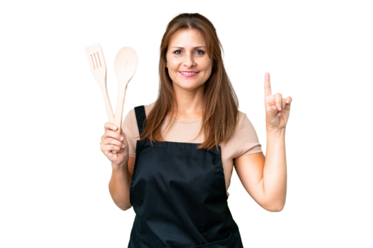 Middle age caucasian woman holding a rolling pin over isolated background pointing up a great idea