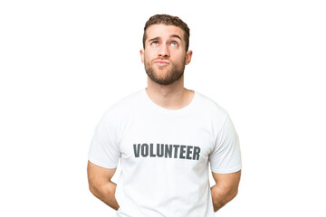 Fototapeta premium Young volunteer man over isolated chroma key background and looking up