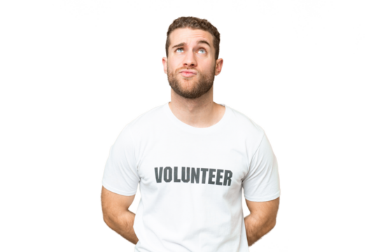 Young volunteer man over isolated chroma key background and looking up