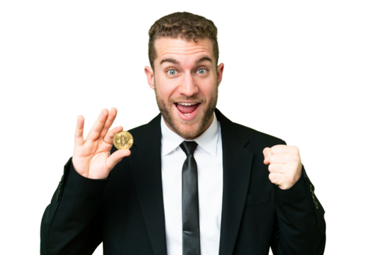 Young business blonde man holding a Bitcoin over isolated chroma key background celebrating a victory in winner position