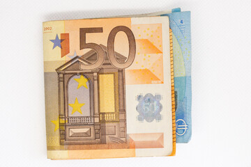Euro banknotes on a white background representing European currency and finance