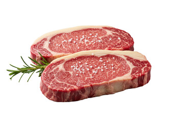 Two raw premium beef ribeye steaks, crimson red, white marbling, fat, garnished with rosemary, sea salt on transparent background. Culinary marketing concept