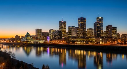 Fototapeta premium Night Skyline of Modern City with Tall Skyscrapers and Reflection in Water
