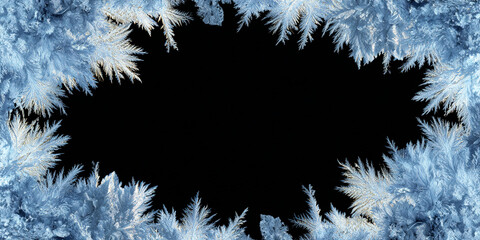 Intricate frost patterns in shades of blue and white form a delicate border against a black background.