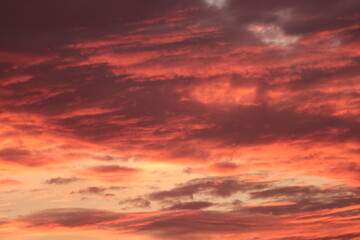 Apocalyptic Skyscape. Dramatic Indian Sunset with Dark Storm Clouds and Fiery Red Sunbeams, concept of Kali Yuga, divine wrath and power.