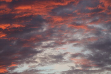 Aerial view of beautiful pink and orange clouds at sunset. Abstract natural background for design, banner, wallpaper. Peaceful and romantic sky.