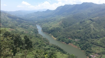 Scenic Mountain Valley with River Surrounded by Green Hills and Forests