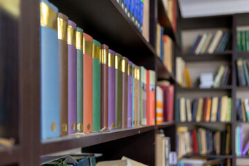 Various types of books on a library shelf