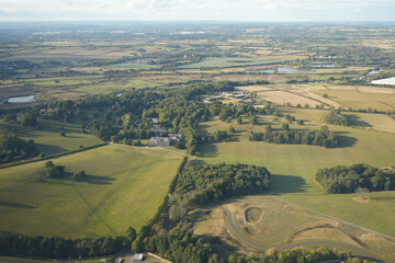 East Midlands Airport, England – September 5 2025: Aerial view of green countryside and historic estate during evening light.
