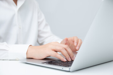 Businessman typing on a laptop at workplace. Concept of business communication, office work, professional technology use, and corporate digital lifestyle