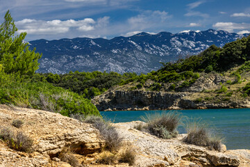Azure water in the Adriatic Sea, rocky coast of the island of Rab, cloudy, threatening sky, Strucic...