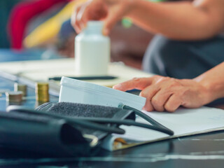 Senior woman is taking notes retirement savings and health care expenses. Retired senior is planning health care and finances, life planning. Elderly care female note and check medicine. Lifestyle 