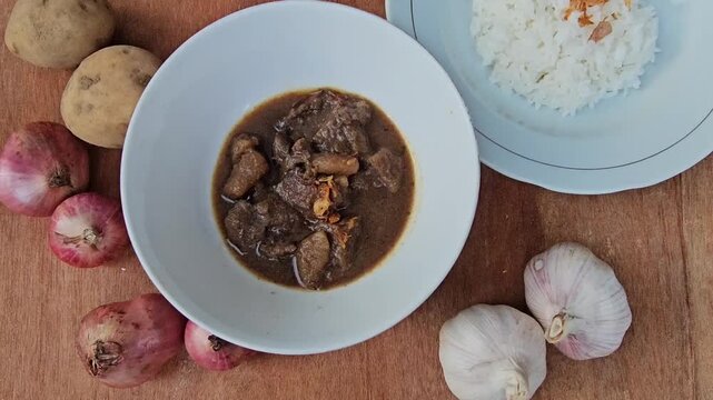 tea and cookies,Semur daging is an Indonesian meat stew in thick brown gravy,served with steamed rice